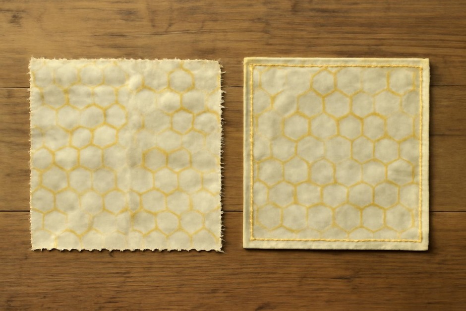 Two beeswax wraps on a wooden table, one simple no‑sew square and one neatly sewn with stitching around the edge
